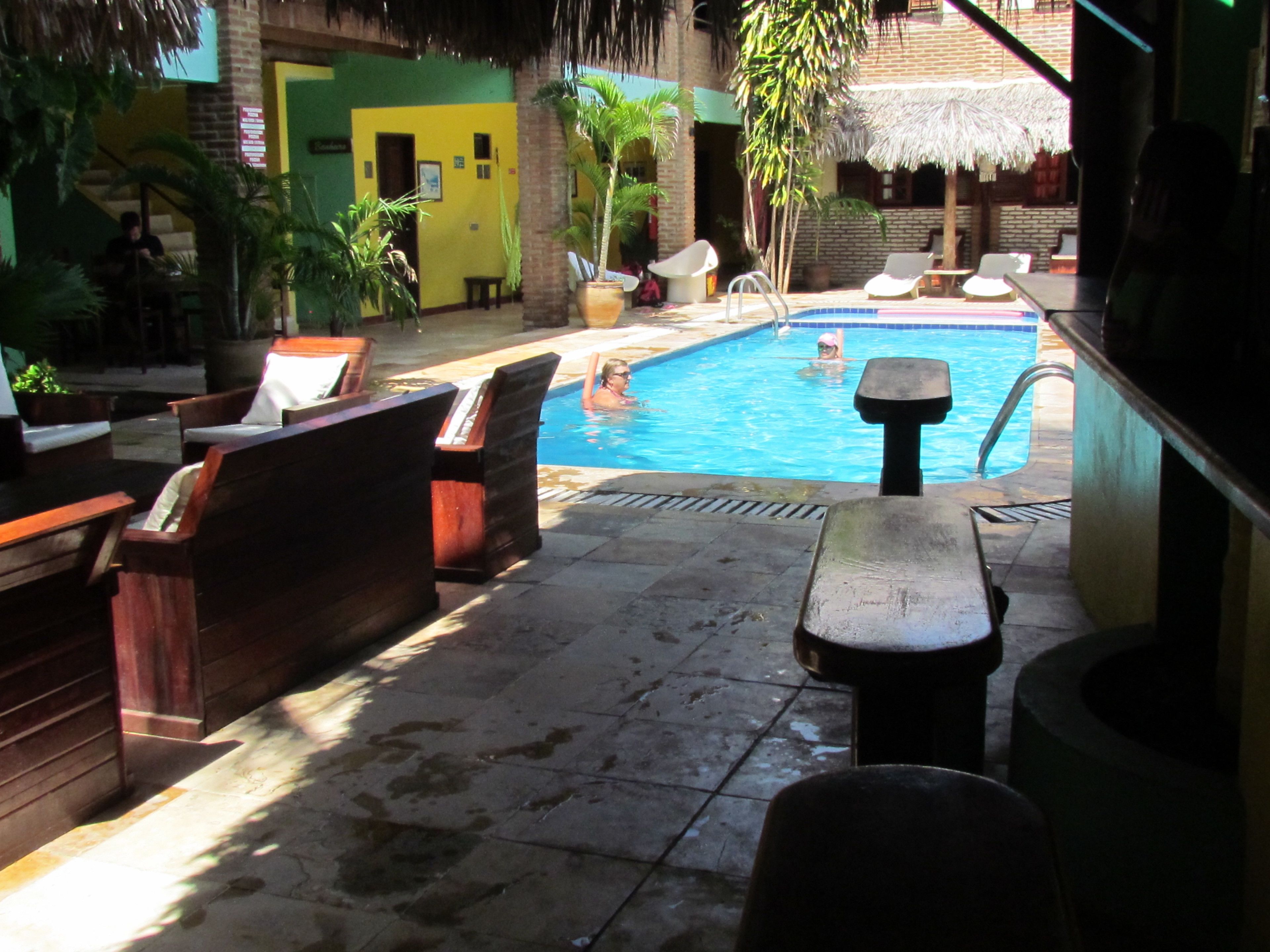 A pool area with lounge chairs and a small pool.