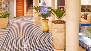 A lobby with checkered flooring, large columns, and a staircase leading to upper floors. - Riad Andalib (Fes)