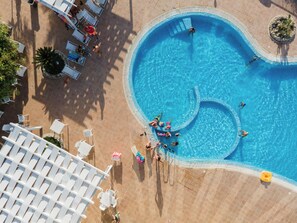 An aerial view of a swimming pool with lounge chairs and a poolside area. - Villaggio Marco Polo (Ricadi)