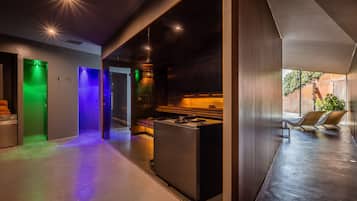 Stylish hallway leads to a kitchen area with a stainless steel stove.