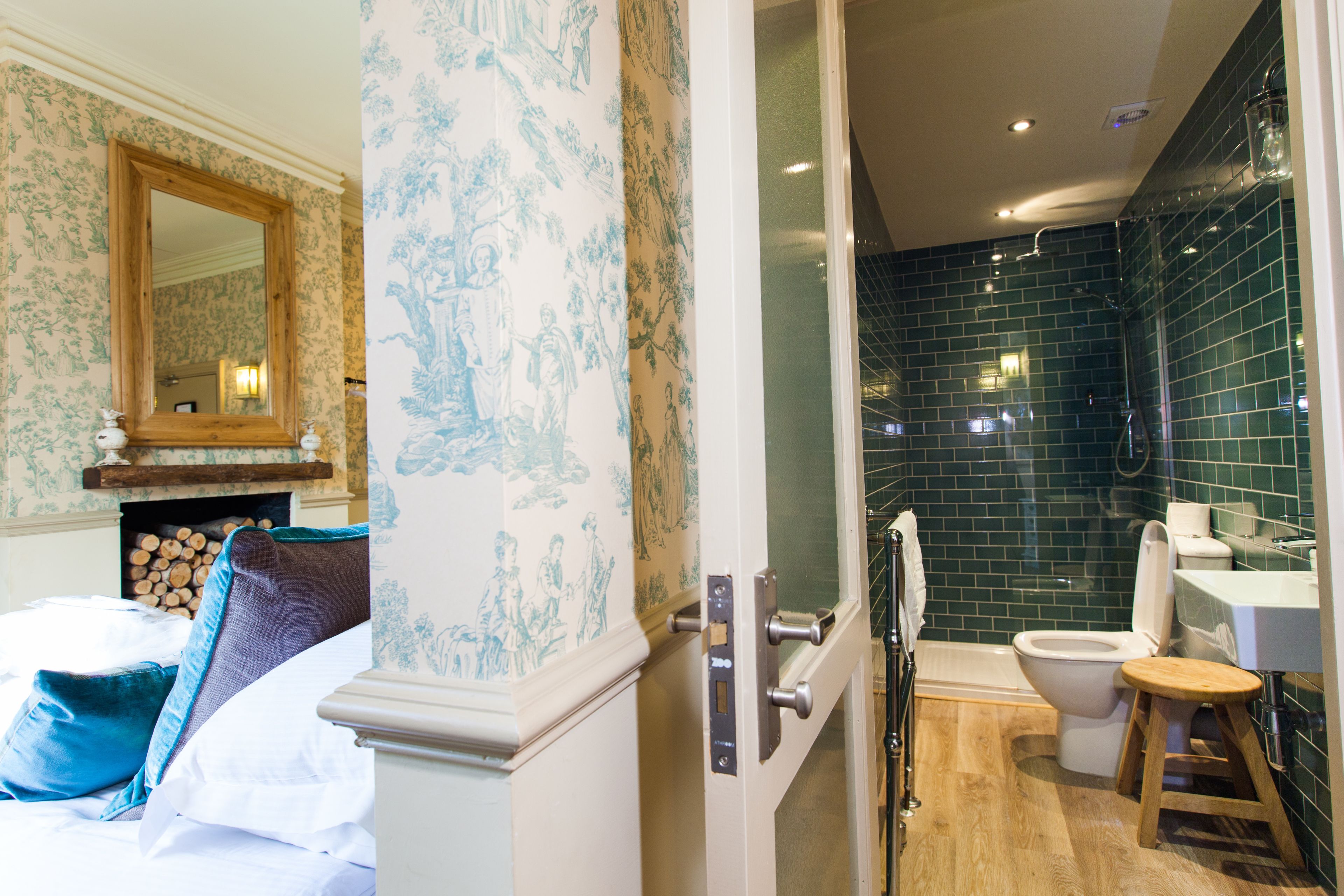 A bathroom with a bathtub, toilet, and a shower area.
