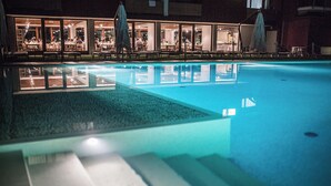 A swimming pool with a clear view of the adjacent restaurant area.
