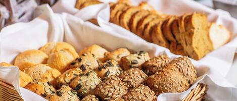 A variety of breads and pastries in a basket.