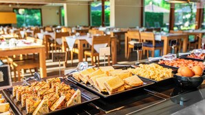 A buffet with various food options including sandwiches, macaroni salad, and eggs.