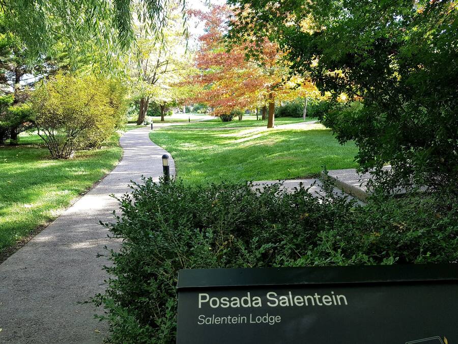 A pathway leading to a sign for Salentein Lodge.