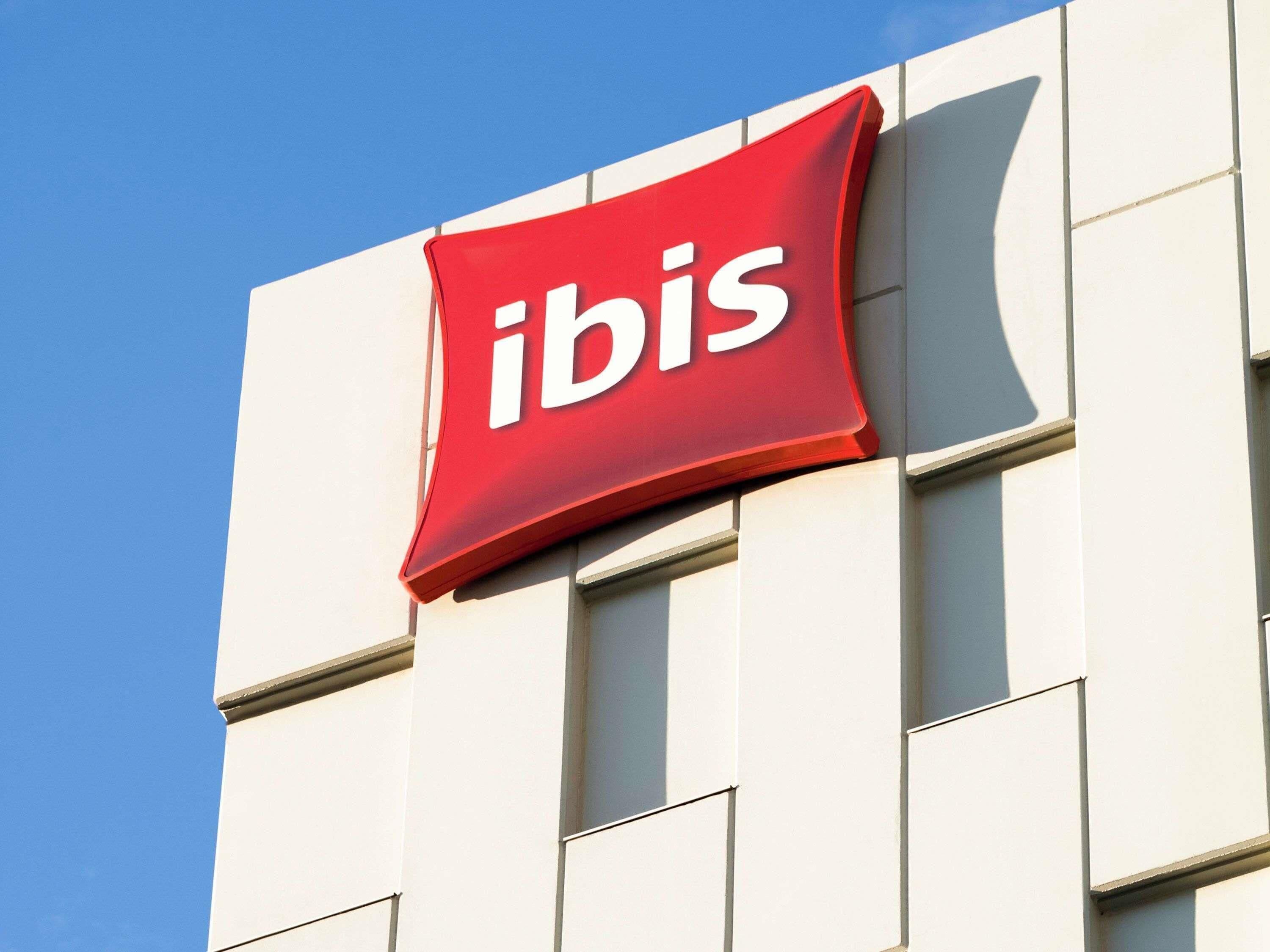 A building with a prominent red sign reading 'ibis.'