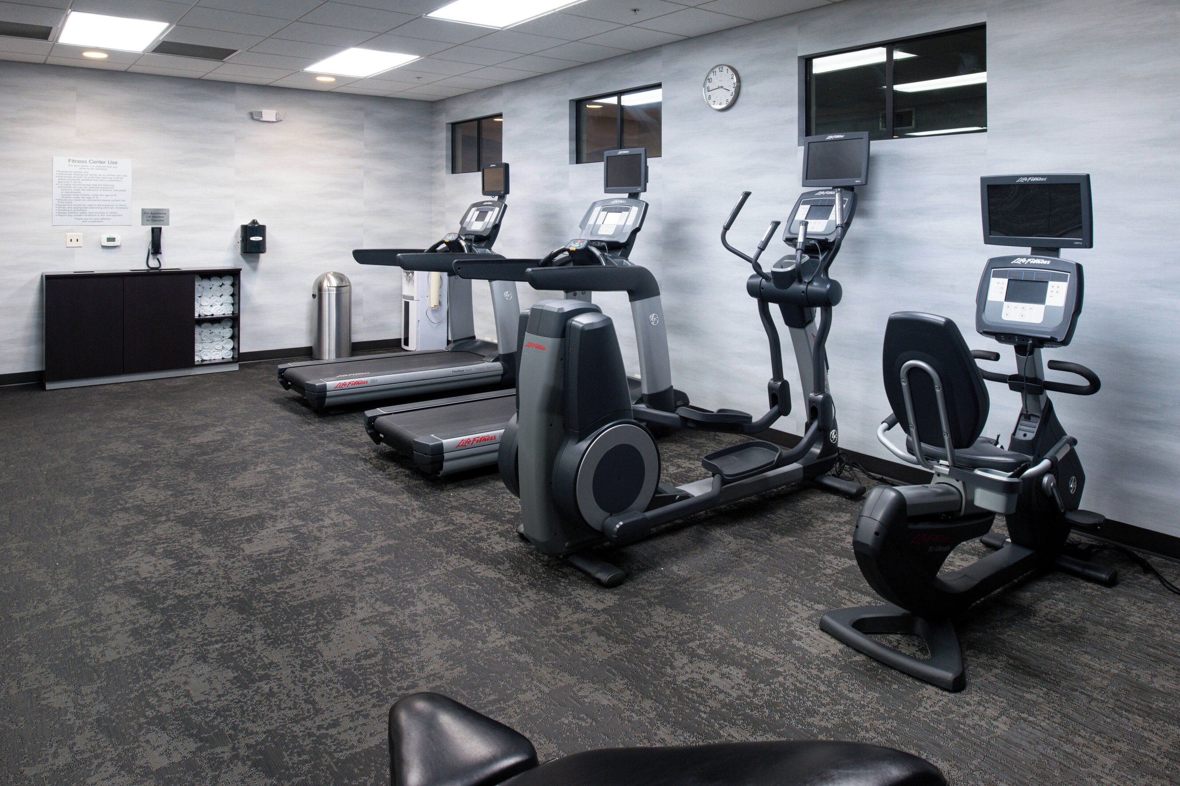 A fitness center with treadmills, an elliptical, and a stationary bike.