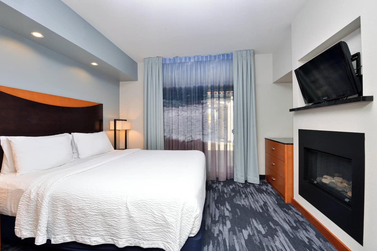 Premium bedding, desk, laptop workspace, blackout curtains