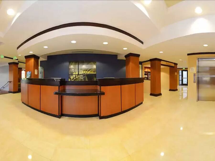 A reception area with a curved counter, a glass display, and an elevator.