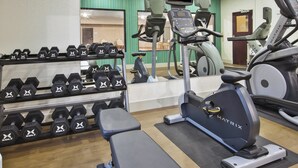 A gym with various exercise equipment including dumbbells, treadmills, and an elliptical machine. - Holiday Inn Express Hotel & Suites Niles by IHG (Niles)
