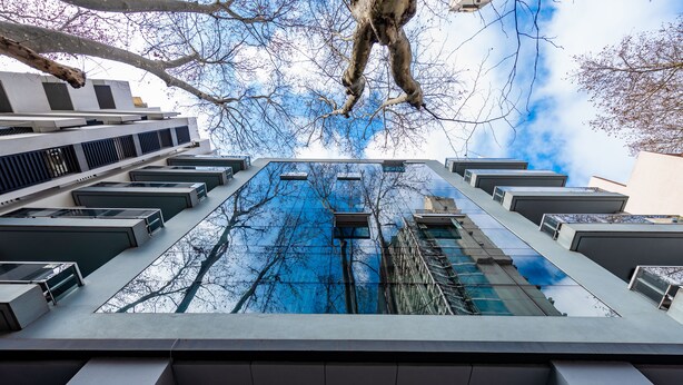 A modern building with a unique architectural design, featuring a central atrium with a glass ceiling and multiple levels. - Hotel Bys Palermo (Buenos Aires)