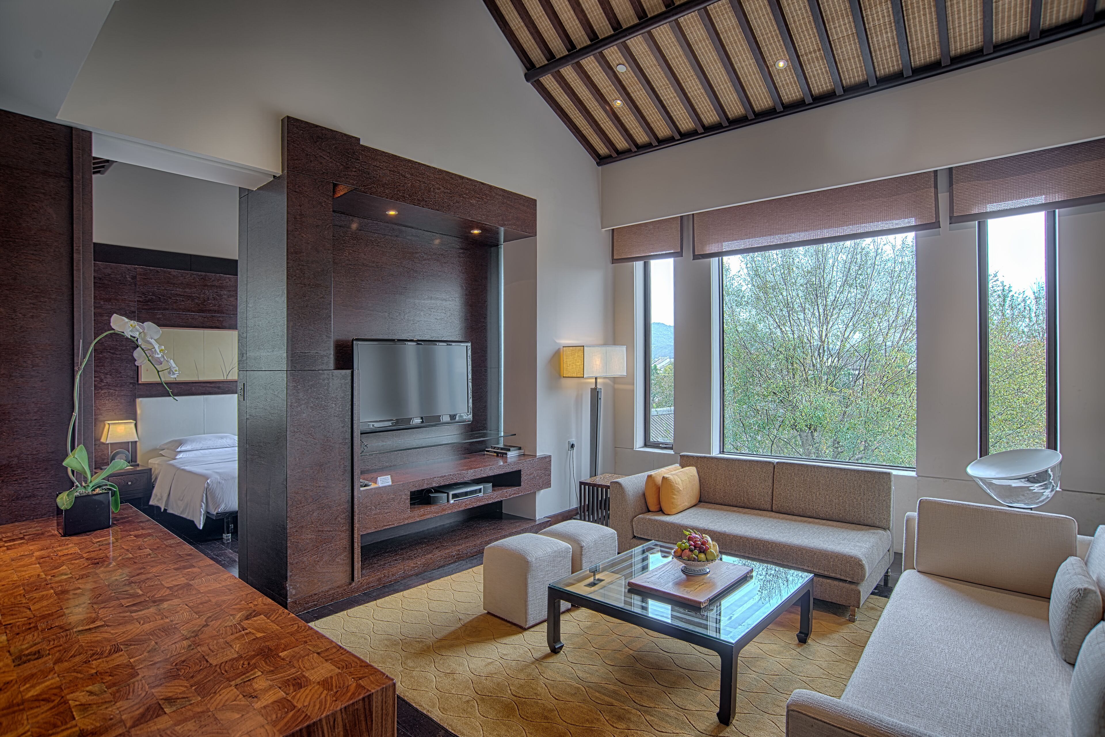 A modern living room with a TV, sofa, and coffee table.