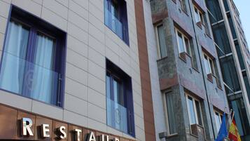 A multi-story building with a restaurant on the ground floor.