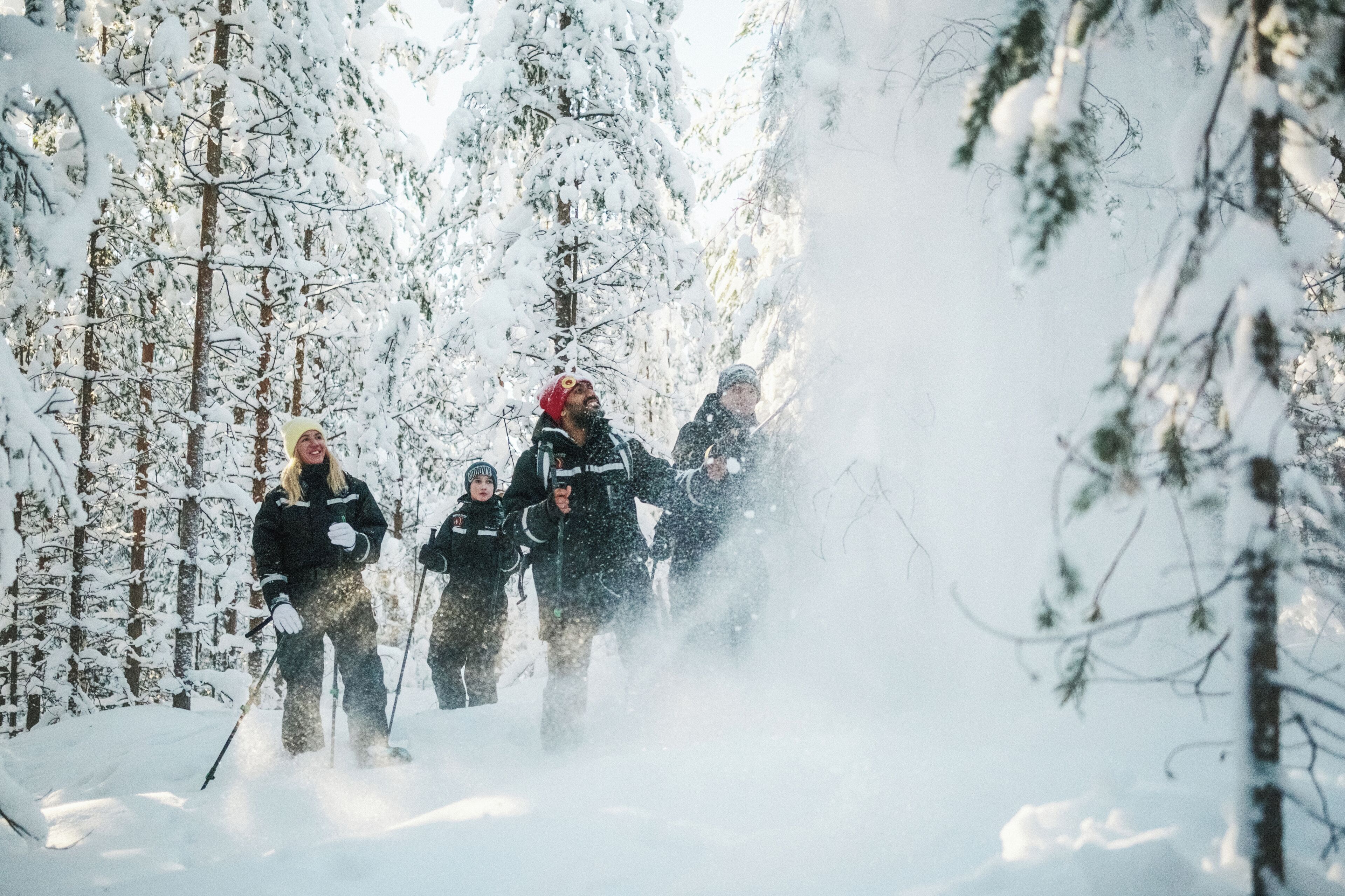Un grupo de personas esquiando en un bosque nevado.