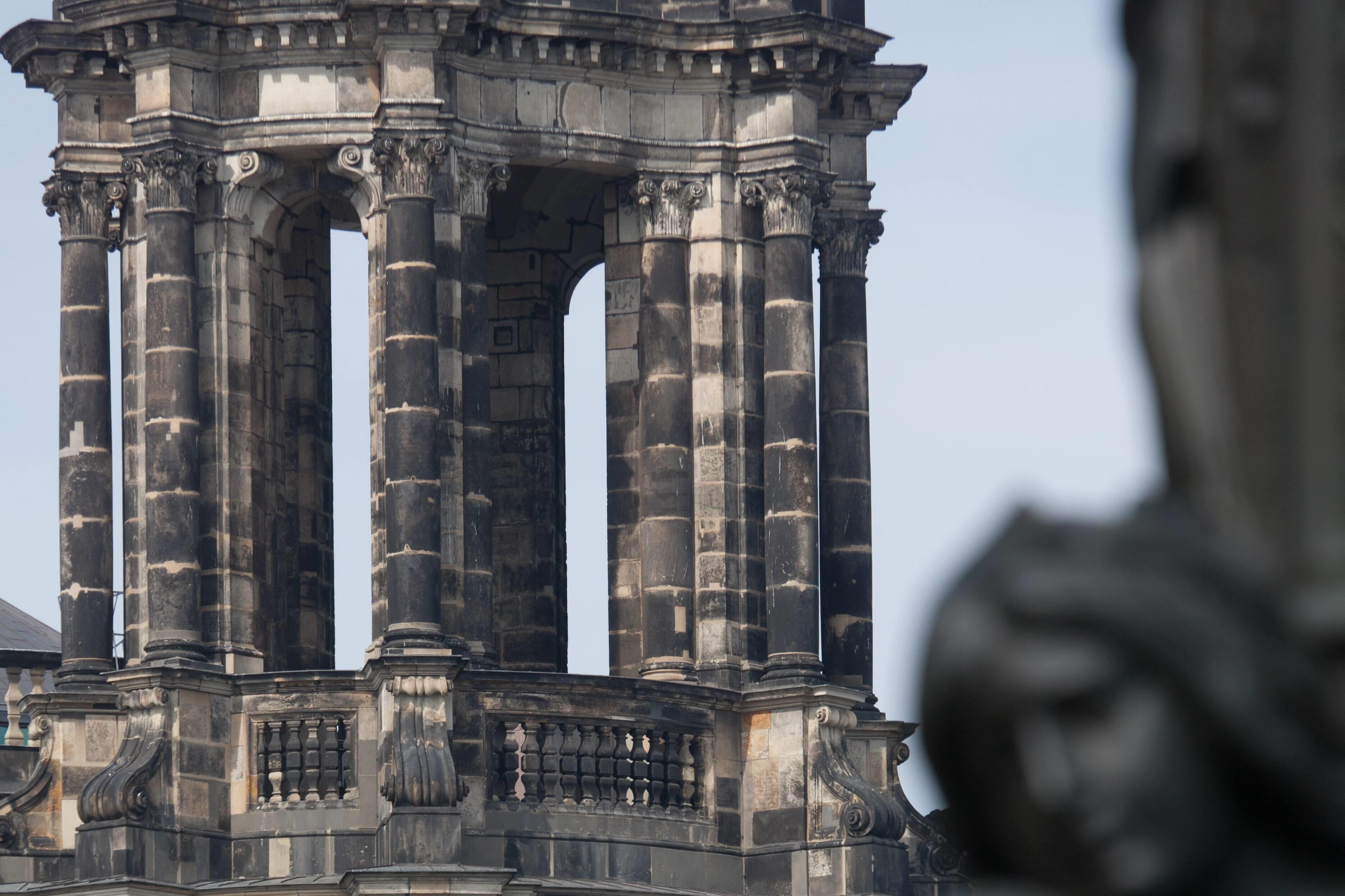 A historical stone structure with columns and intricate carvings.