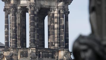 A historical stone structure with columns and intricate carvings.
