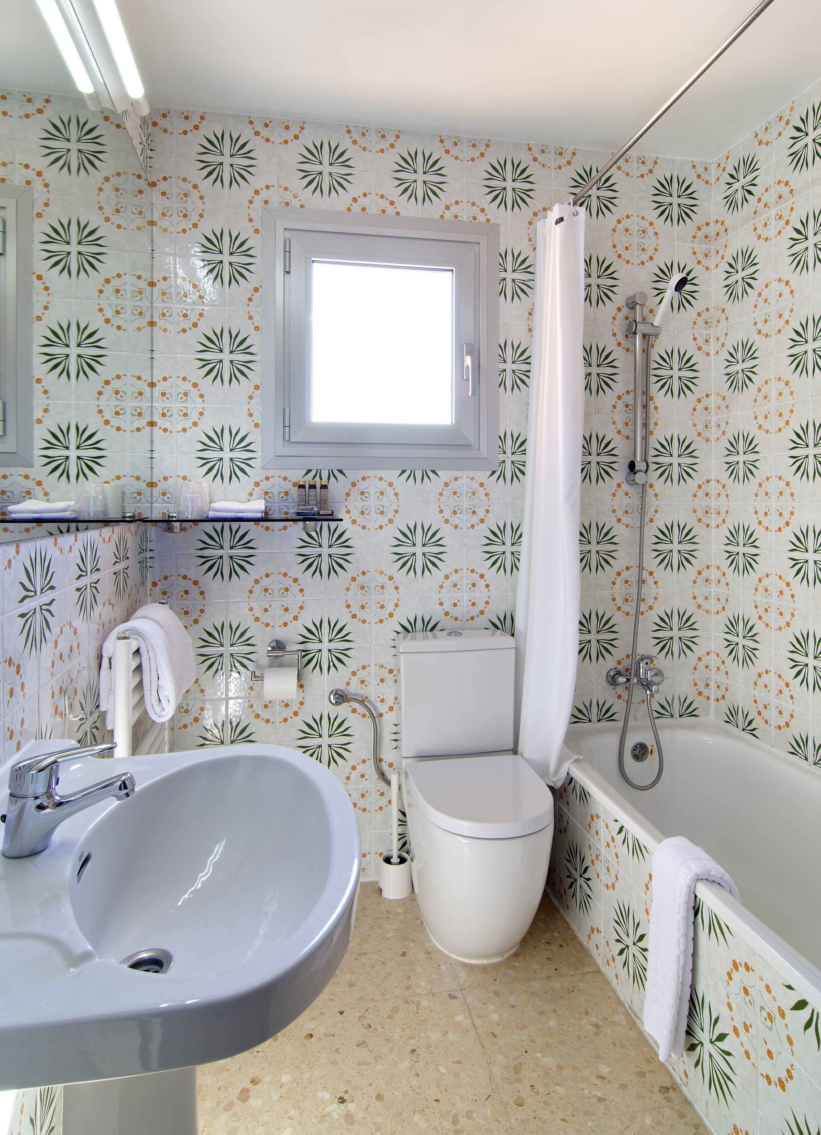 A bathroom with a sink, toilet, and bathtub.