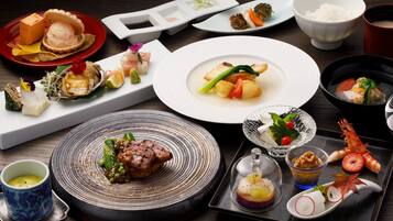 A variety of dishes on a table, including seafood, vegetables, and a meat dish, suggesting a diverse meal selection.