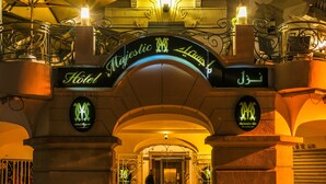The entrance to Majestic Hotel with ornate ironwork and illuminated signs. - Majestic Hotel (Tunis)
