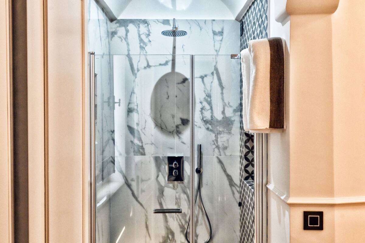 deluxe double room single use, 1 king bed | bathroom | shower, rainfall showerhead, free toiletries, hair dryer