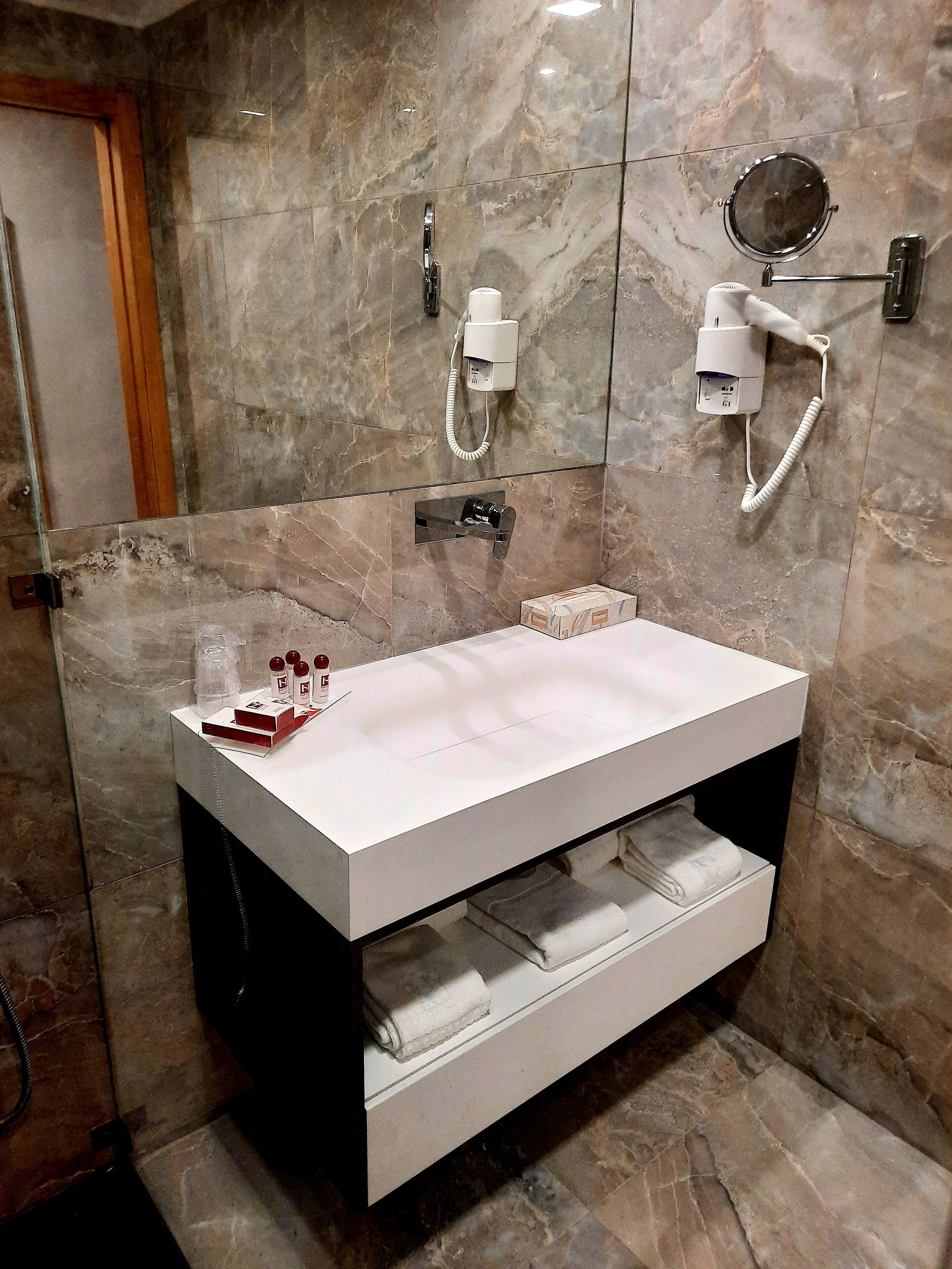 superior twin room | bathroom amenities | hair dryer, towels