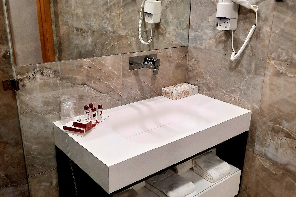 superior twin room | bathroom amenities | hair dryer, towels