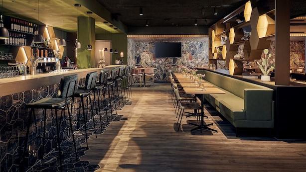 A bar area with a long counter, multiple bar stools, and a seating area with tables and chairs.