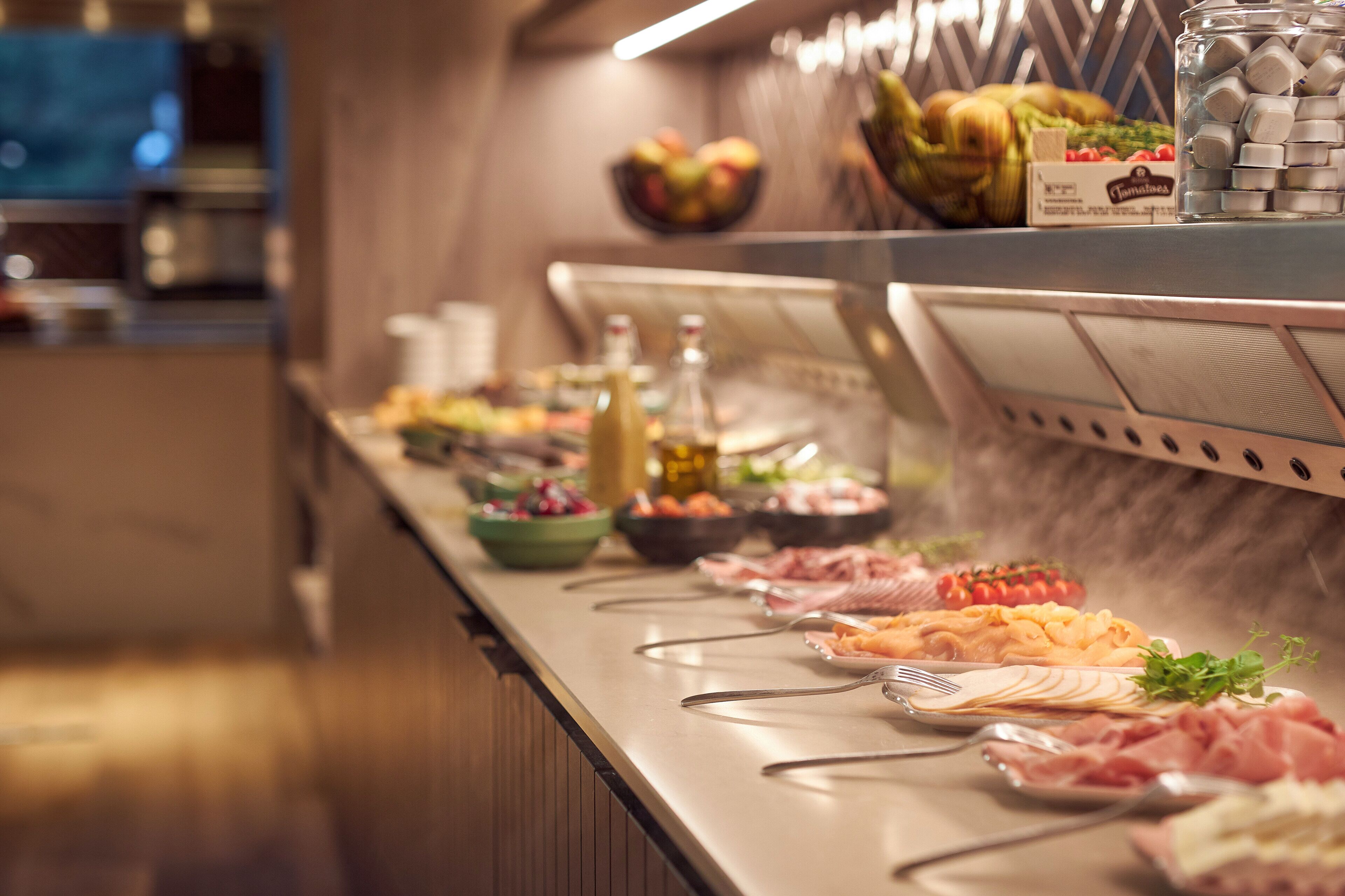 A buffet with various food items and condiments.