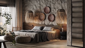 Ein modernes Schlafzimmer mit einem großen Bett, einem Holz-Kopfteil und einer strukturierten Wand.