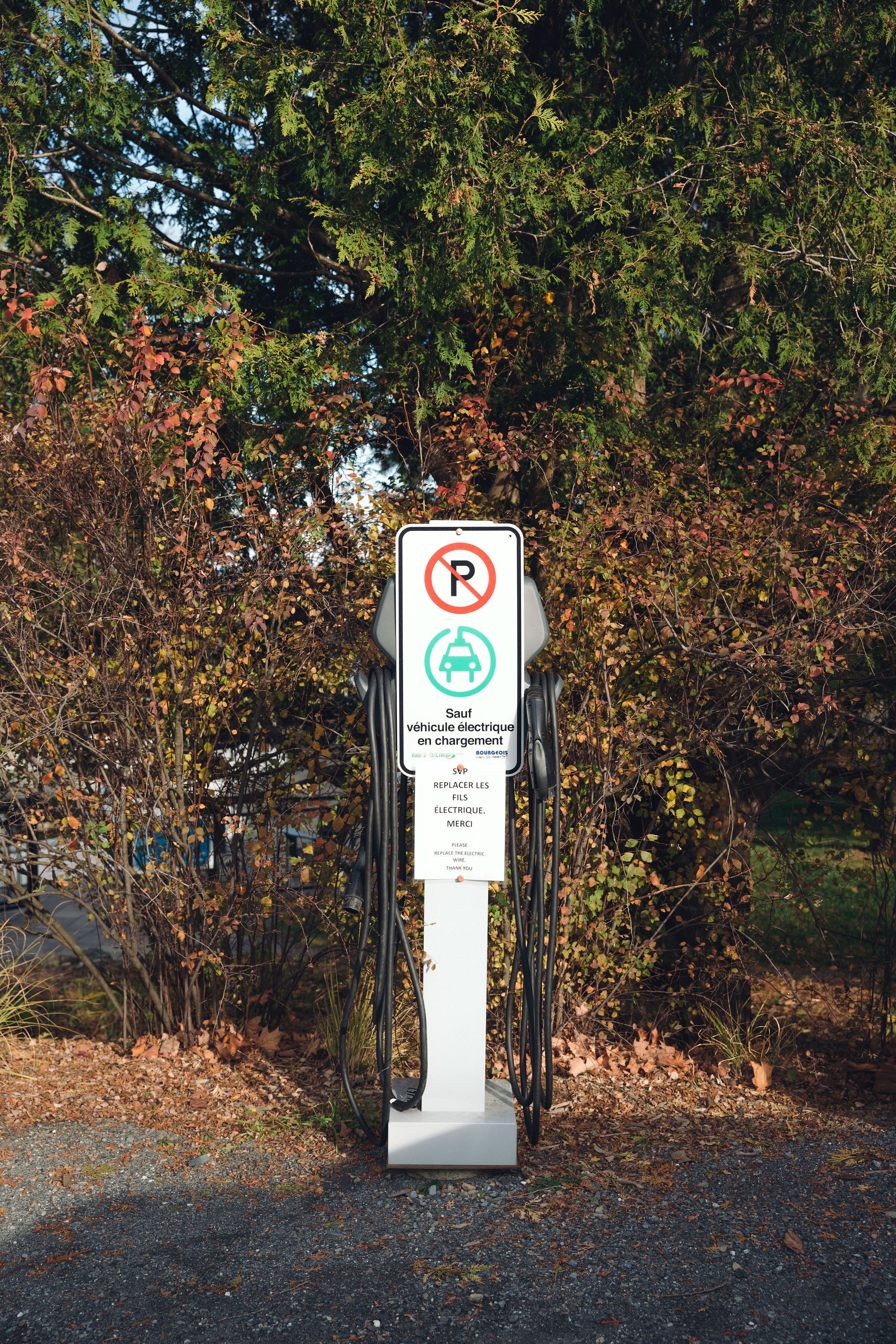 A parking sign with a no parking symbol, a no stopping symbol, and a no stopping for loading symbol.