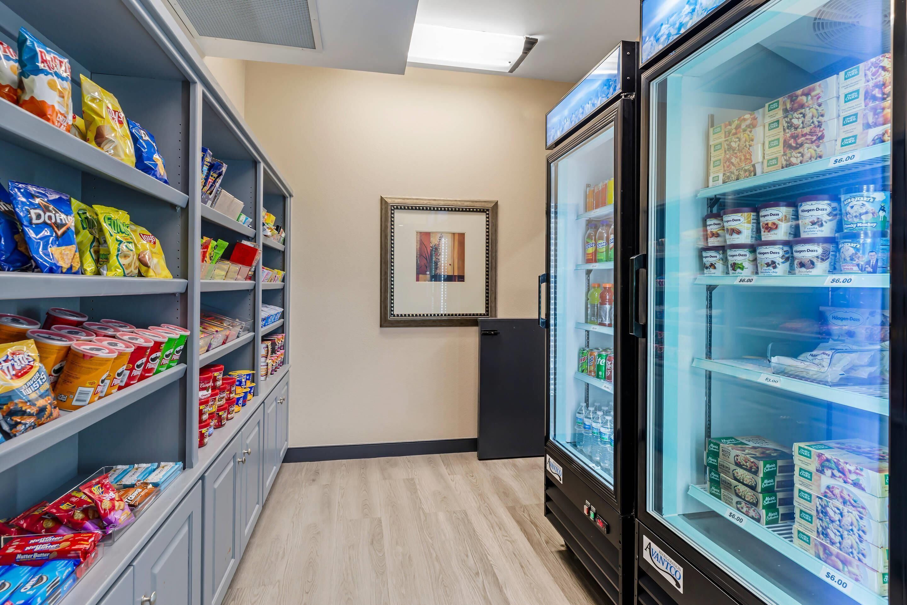 A snack and beverage vending area with various packaged goods and refrigerated items.