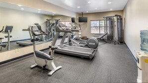 A gym with treadmills, a stationary bike, and a weight machine. - Country Inn & Suites by Radisson, Ashland - Hanover, VA (Ashland)