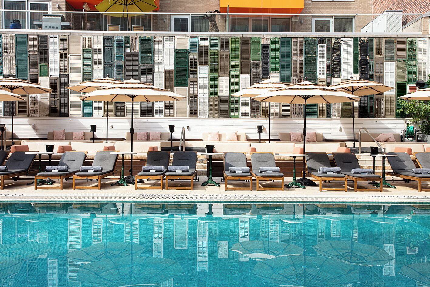 Seasonal outdoor pool, open 10:00 AM to 6:30 PM, pool umbrellas