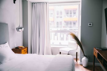 Hotel amenities such as safe, desk and work area at CODA Williamsburg