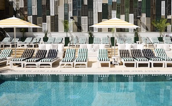 Seasonal outdoor pool, open 10:00 AM to 6:30 PM, pool umbrellas at CODA Williamsburg