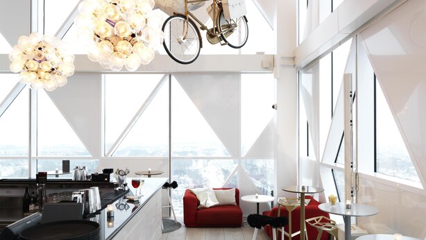 Un interior moderno con una zona de cocina, un sofá rojo y una bicicleta colgada del techo.