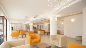A spacious lobby with modern seating and a curved ceiling design. - Oasiclub Hotel (Vieste)
