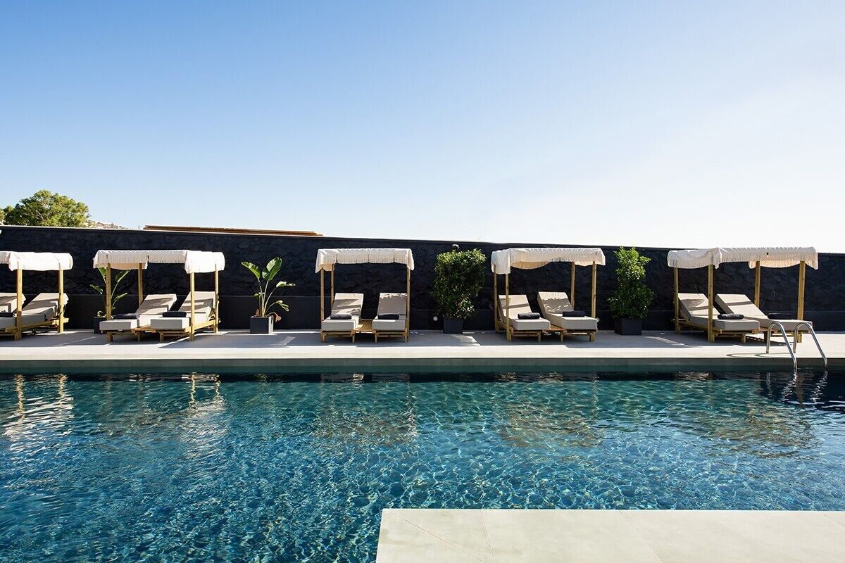 A poolside area with lounge chairs and umbrellas.