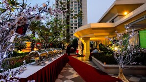 A hotel lobby with a checkered floor, a red carpet, and a row of buffet stations. - Batavia Hotel and Serviced Apartments (Jakarta)