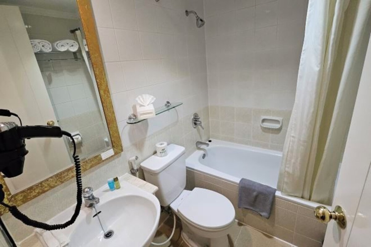 A bathroom with a sink, toilet, bathtub, and shower.