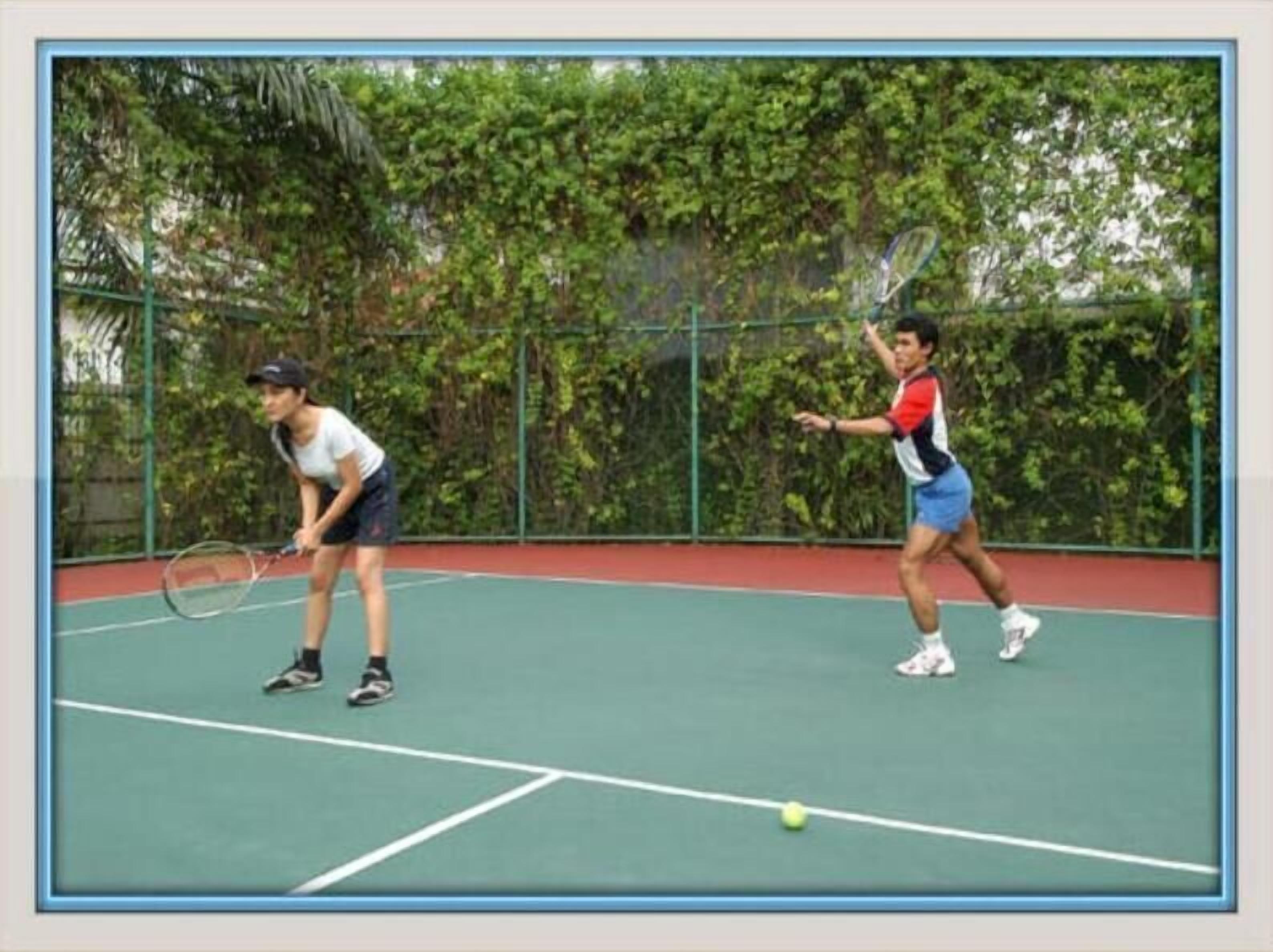 Un court de tennis où s’affrontent deux joueurs.