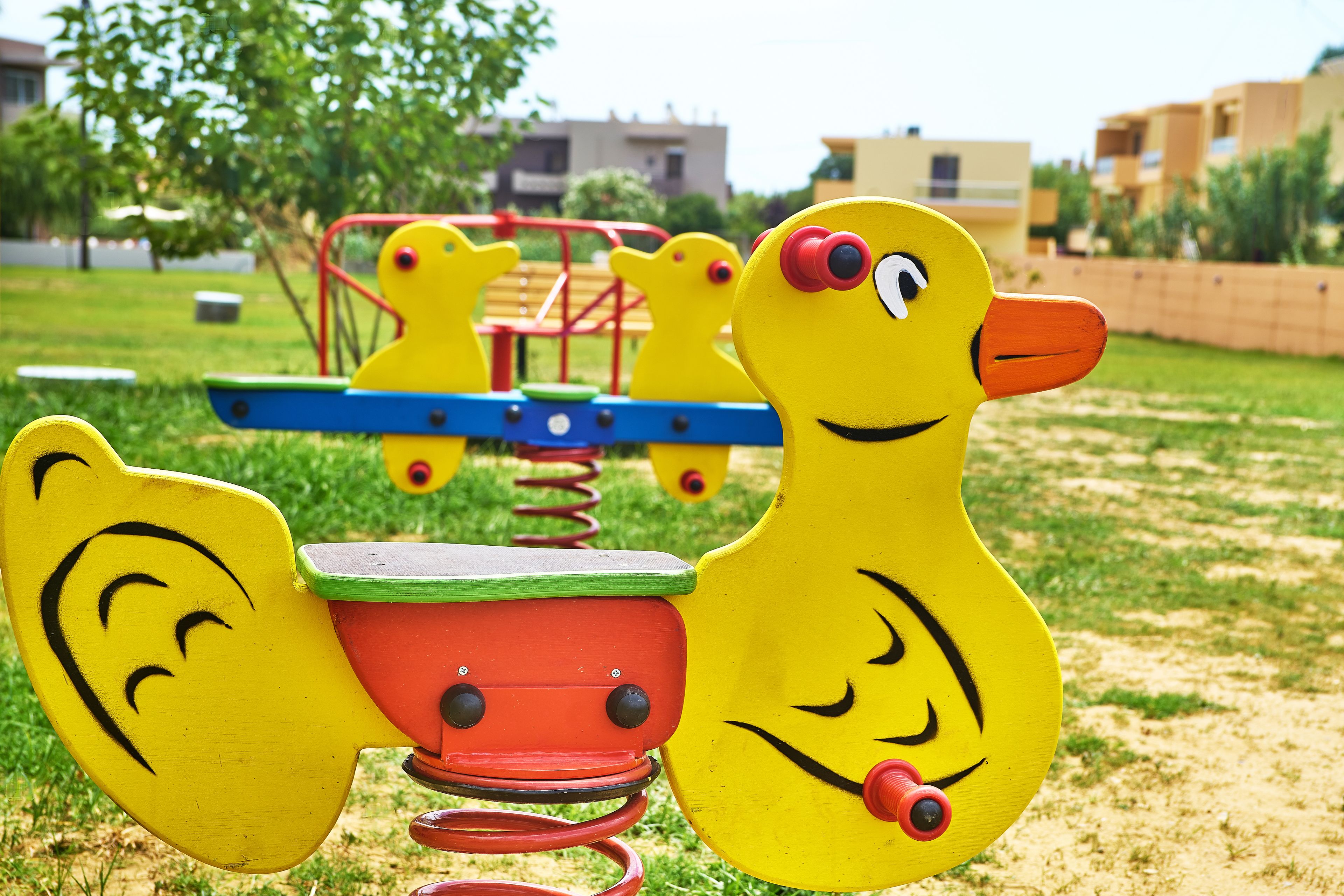 A playground with yellow animal-shaped play structures.