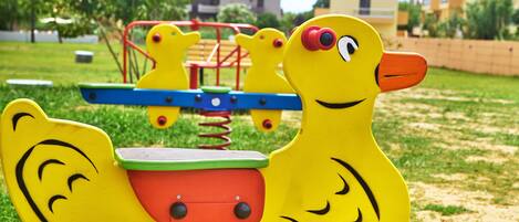 A playground with yellow animal-shaped play structures.