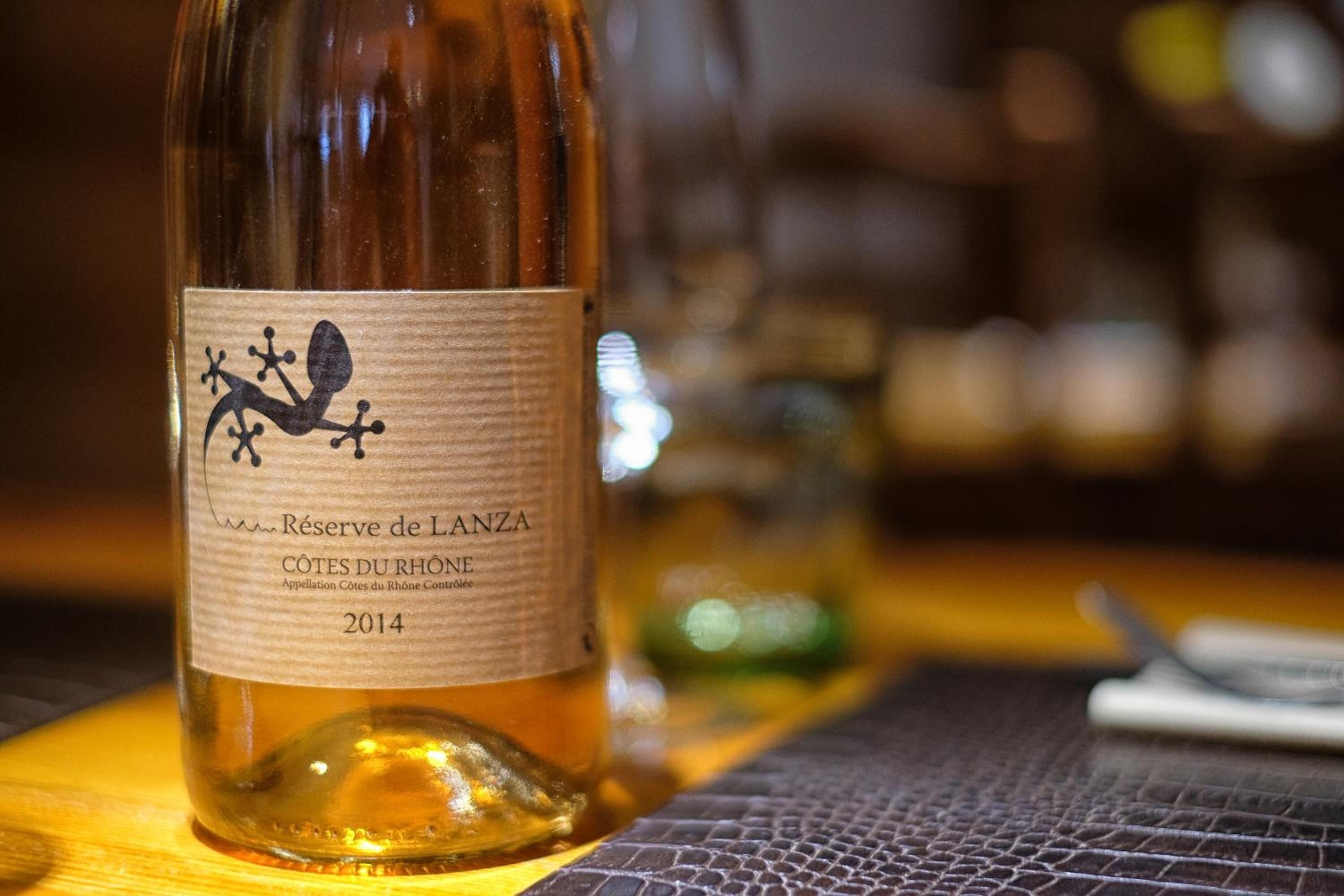 A bottle of wine with a label that includes the text "Reserve de Lanza" and "Côtes du Rhône 2014".
