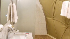 A bathroom with a wooden floor, a white sink, a mirror, and a towel rack. - Beyond Wadi Rum Camp (Wadi Rum)