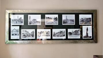 A bulletin board with multiple black and white photographs of buildings and landscapes.