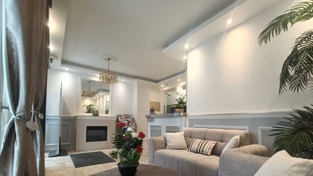 A modern living room with a sofa set, a coffee table, and a fireplace. - Hôtel du Parc (Aulnay-sous-Bois)