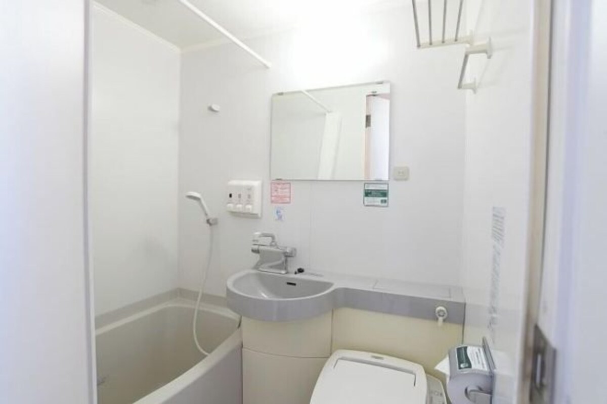 A small bathroom with a bathtub, sink, and toilet.