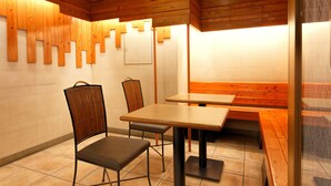 A restaurant interior with wooden panel walls, a tiled floor, and a seating area with tables and chairs. - Washington R&B Hotel Hakata Ekimae Dai 1 (Fukuoka)