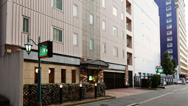 A hotel with a modern facade, a gated entrance, and a visible sign indicating the hotel name. - Washington R&B Hotel Hakata Ekimae Dai 1 (Fukuoka)